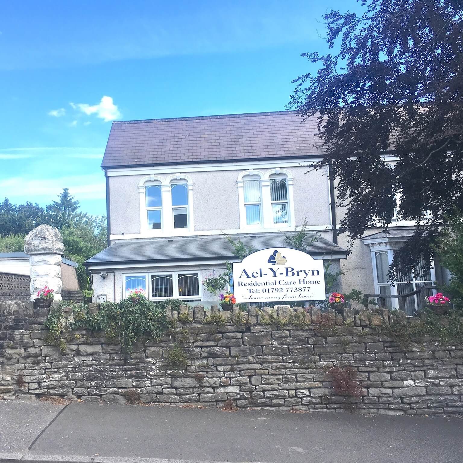 Ael-Y-Bryn Care Home - Cozy communal living area with residents enjoying activities